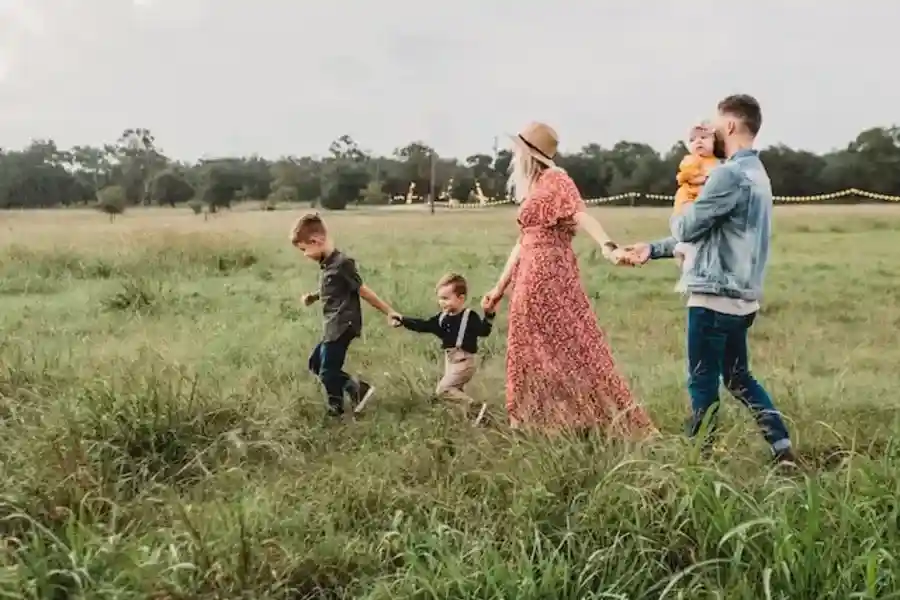 woman holding man and toddler hands during daytime - American Holidays (Labor Day)